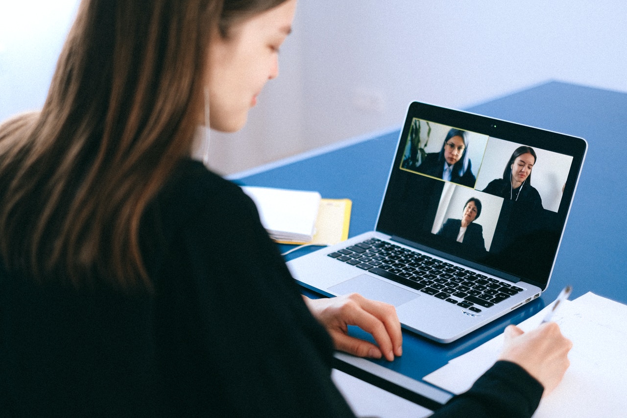 woman having an online meeting with three other people